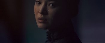 Movie still from “The Grandmaster” (2013), directed by Kar-Wai Wong – A woman's face with tears coming out of her eyes; Close Up shot, Low angle