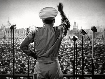 Movie still from “The Great Dictator” (1940), directed by Charles Chaplin – An old photo of a man standing in front of a crowd; Wide shot, Low angle
