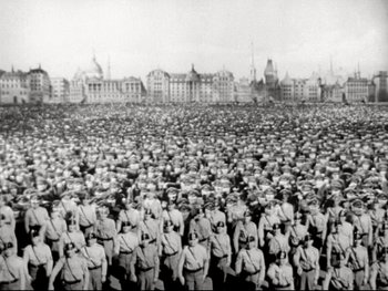 Movie still from “The Great Dictator” (1940), directed by Charles Chaplin – A black and white photo of a large crowd of people; Extreme Wide shot, High angle