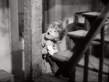 Movie still from “The Great Dictator” (1940), directed by Charles Chaplin – A young girl is looking up at the camera; Medium shot, High angle