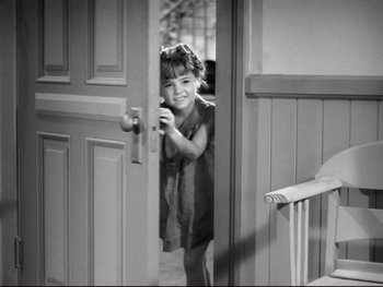 Movie still from “The Great Dictator” (1940), directed by Charles Chaplin – A little girl peeks through the door of a house; Medium shot, High angle