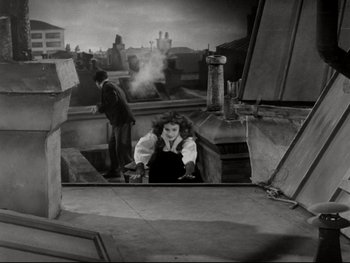 Movie still from “The Great Dictator” (1940), directed by Charles Chaplin – An old photo of a man and a woman looking in a mirror; Wide shot, Overhead angle