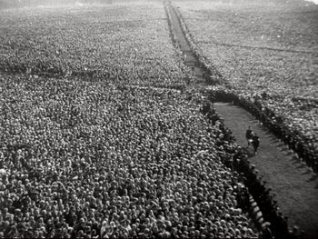 Movie still from “The Great Dictator” (1940), directed by Charles Chaplin – A large group of people gathered in a large field; Extreme Wide shot, High angle