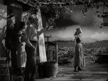 Movie still from “The Great Dictator” (1940), directed by Charles Chaplin – A black and white photo of a man and a woman; Wide shot, Low angle