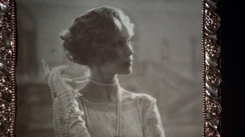 Movie still from “The Great Gatsby” (1974), directed by Jack Clayton – An old photo of a woman wearing a dress and pearls; Close Up shot, Low angle