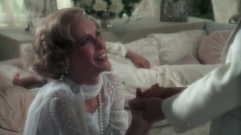Movie still from “The Great Gatsby” (1974), directed by Jack Clayton – An older woman holding hands with a younger woman; Close Up shot, Over the shoulder angle
