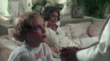 Movie still from “The Great Gatsby” (1974), directed by Jack Clayton – Two women sitting on a couch in a living room; Close Up shot, Over the shoulder angle