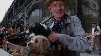 Movie still from “The Great Gatsby” (1974), directed by Jack Clayton – An old man holding a dog and a cat; Medium shot, Low angle