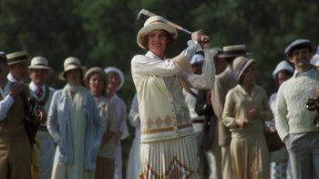 Movie still from “The Great Gatsby” (1974), directed by Jack Clayton – A woman in a white hat is swinging a golf club; Medium shot, Low angle