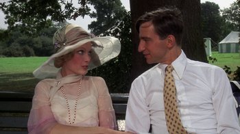 Movie still from “The Great Gatsby” (1974), directed by Jack Clayton – A man and a woman sitting next to each other on a park bench; Close Up shot, Low angle