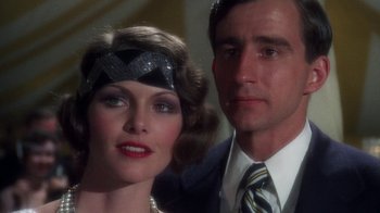Movie still from “The Great Gatsby” (1974), directed by Jack Clayton – A man and a woman posing for a picture; Close Up shot, Low angle