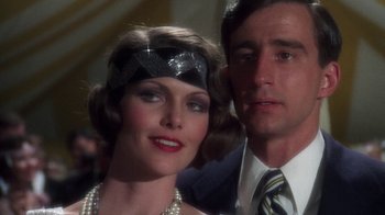 Movie still from “The Great Gatsby” (1974), directed by Jack Clayton – A man and a woman posing for a picture; Close Up shot, Low angle