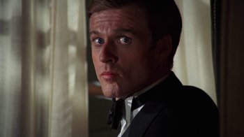 Movie still from “The Great Gatsby” (1974), directed by Jack Clayton – A person wearing a suit and tie; Close Up shot, Low angle
