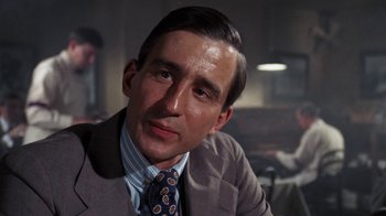 Movie still from “The Great Gatsby” (1974), directed by Jack Clayton – A person wearing a suit and a tie; Close Up shot, Low angle