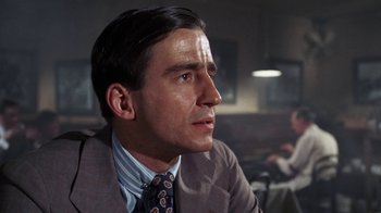 Movie still from “The Great Gatsby” (1974), directed by Jack Clayton – A person wearing a suit and tie; Close Up shot, Over the shoulder angle