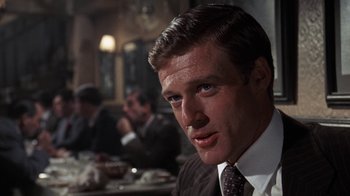 Movie still from “The Great Gatsby” (1974), directed by Jack Clayton – A person wearing a suit and tie; Close Up shot, Over the shoulder angle
