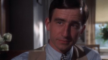 Movie still from “The Great Gatsby” (1974), directed by Jack Clayton – A person wearing a suit and tie; Close Up shot, Over the shoulder angle