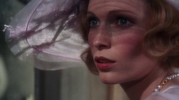 Movie still from “The Great Gatsby” (1974), directed by Jack Clayton – A woman's face with a purple hat; Close Up shot, Over the shoulder angle