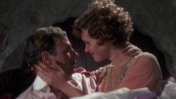 Movie still from “The Great Gatsby” (1974), directed by Jack Clayton – A man and a woman embracing each other in a room; Close Up shot, Overhead angle