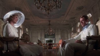 Movie still from “The Great Gatsby” (1974), directed by Jack Clayton – A living room filled with lots of furniture and high ceilings; Wide shot, Low angle