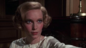 Movie still from “The Great Gatsby” (1974), directed by Jack Clayton – A person wearing a white dress; Close Up shot, Over the shoulder angle