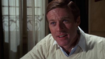 Movie still from “The Great Gatsby” (1974), directed by Jack Clayton – A person wearing a white sweater; Close Up shot, Over the shoulder angle