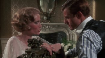 Movie still from “The Great Gatsby” (1974), directed by Jack Clayton – A man and a woman looking at each other; Close Up shot, Over the shoulder angle