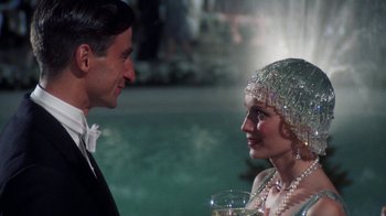 Movie still from “The Great Gatsby” (1974), directed by Jack Clayton – A man and a woman are talking to each other; Close Up shot, Over the shoulder angle