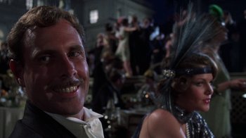 Movie still from “The Great Gatsby” (1974), directed by Jack Clayton – A man and a woman are smiling for the camera; Close Up shot, Low angle