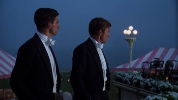Movie still from “The Great Gatsby” (1974), directed by Jack Clayton – Two men in tuxedos standing next to each other; Medium shot, Low angle