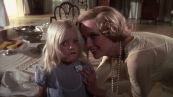 Movie still from “The Great Gatsby” (1974), directed by Jack Clayton – A woman and a little girl posing for a picture; Close Up shot, Over the shoulder angle