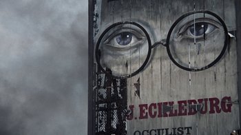 Movie still from “The Great Gatsby” (1974), directed by Jack Clayton – An advertisement of a man's face with glasses on a building; Extreme Close Up shot, Low angle