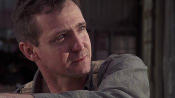 Movie still from “The Great Gatsby” (1974), directed by Jack Clayton – A person sitting down with his eyes closed; Close Up shot, Low angle