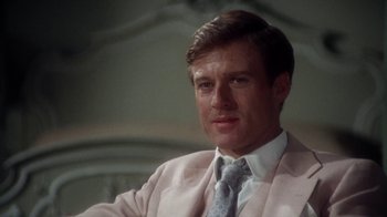 Movie still from “The Great Gatsby” (1974), directed by Jack Clayton – A person wearing a suit and tie; Close Up shot, Over the shoulder angle