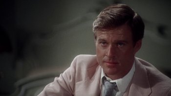 Movie still from “The Great Gatsby” (1974), directed by Jack Clayton – A person wearing a suit and tie; Close Up shot, Over the shoulder angle