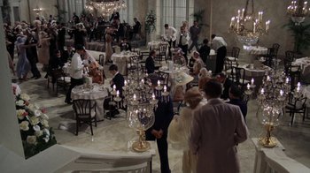 Movie still from “The Great Gatsby” (1974), directed by Jack Clayton – A group of people standing around a restaurant; Extreme Wide shot, High angle