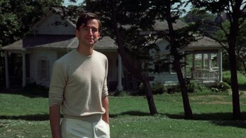 Movie still from “The Great Gatsby” (1974), directed by Jack Clayton – A man standing in front of some trees; Medium shot, Low angle