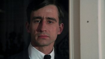 Movie still from “The Great Gatsby” (1974), directed by Jack Clayton – A person wearing a suit and tie; Close Up shot, Low angle