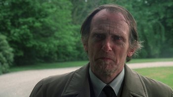 Movie still from “The Great Gatsby” (1974), directed by Jack Clayton – A person wearing a suit and tie; Close Up shot, Over the shoulder angle