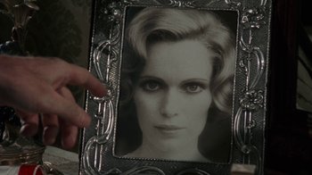 Movie still from “The Great Gatsby” (1974), directed by Jack Clayton – A hand is holding a picture of a woman in an ornate metal frame; Extreme Close Up shot, Over the shoulder angle
