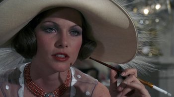 Movie still from “The Great Gatsby” (1974), directed by Jack Clayton – A person wearing a hat and holding a brush; Close Up shot, Low angle