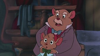 Movie still from “The Great Mouse Detective” (1986), directed by David Michener – A man holding a small mouse next to a large mouse; Close Up shot, Over the shoulder angle