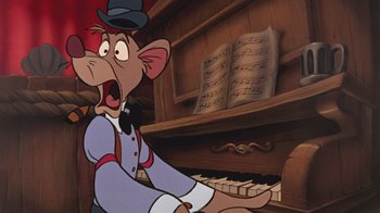 Movie still from “The Great Mouse Detective” (1986), directed by David Michener – A cartoon character sitting in front of a piano; Close Up shot, Low angle
