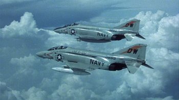 Movie still from “The Great Santini” (1979), directed by Lewis John Carlino – Two fighter jets flying through the air in the sky; Wide shot, Low angle