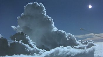 Movie still from “The Great Santini” (1979), directed by Lewis John Carlino – A large cloud formation in the sky with a bird flying above it; Extreme Wide shot, Low angle