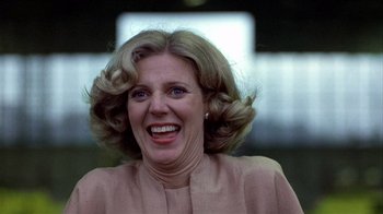 Movie still from “The Great Santini” (1979), directed by Lewis John Carlino – An older woman with blonde curly hair smiling; Close Up shot, Low angle
