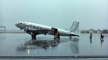 Movie still from “The Great Santini” (1979), directed by Lewis John Carlino – An airplane sitting on top of an airport runway; Wide shot, Low angle