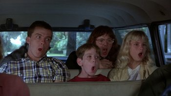 Movie still from “The Great Santini” (1979), directed by Lewis John Carlino – A group of people sitting in the back of a car; Medium shot, Low angle