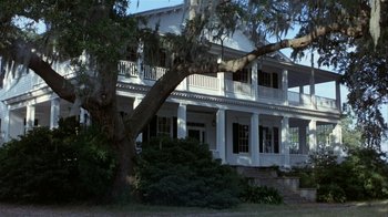 Movie still from “The Great Santini” (1979), directed by Lewis John Carlino – A large white house sitting next to a tree; Extreme Wide shot, Low angle