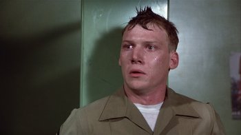 Movie still from “The Great Santini” (1979), directed by Lewis John Carlino – A man with a mohawk haircut looking up at the ceiling; Close Up shot, Low angle